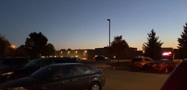 Cars pulling into the Spectrum parking lot early in the morning.