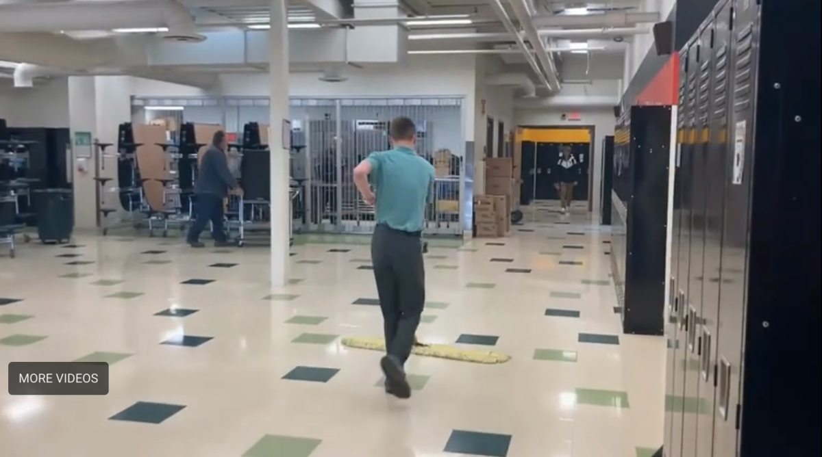 Student and Janitor Paul Lemmerman cleaning up the cafeteria after school hours
