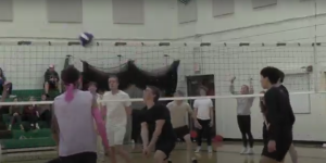 A player on the freshman team prepares to hit the ball over to the other team during the second game of the night