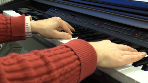 Mrs. Sundberg playing the piano during a Spectrum High school chamber choir rehearsal.