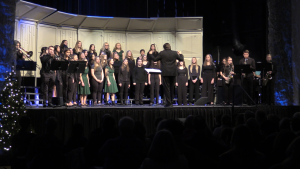 Jazz band students performing "Santa Claus Boogie" with the high school choir. 
