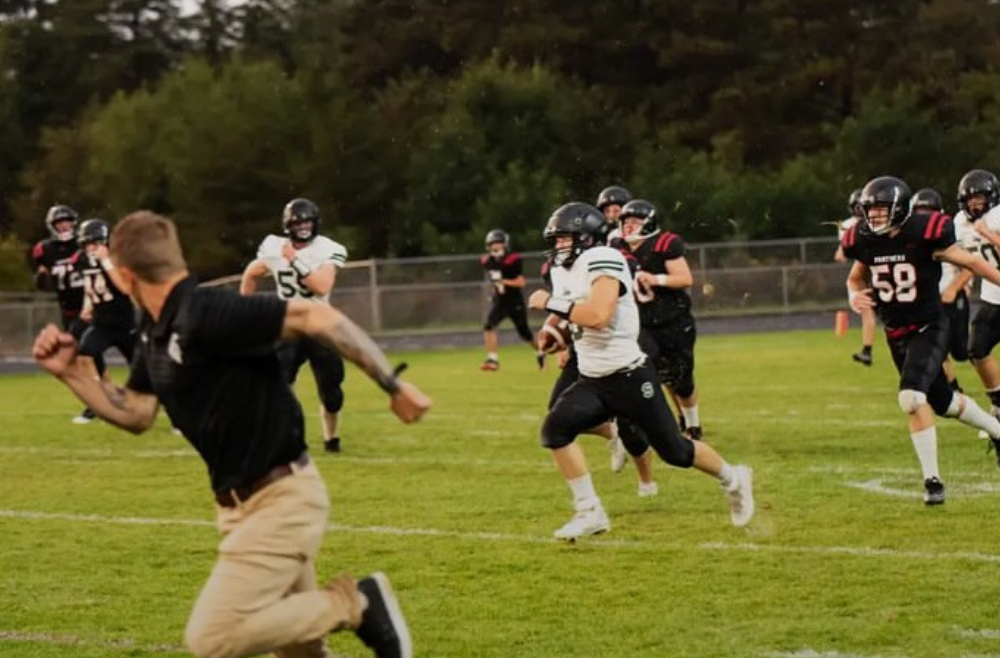 Owen Carlson running down the football field.