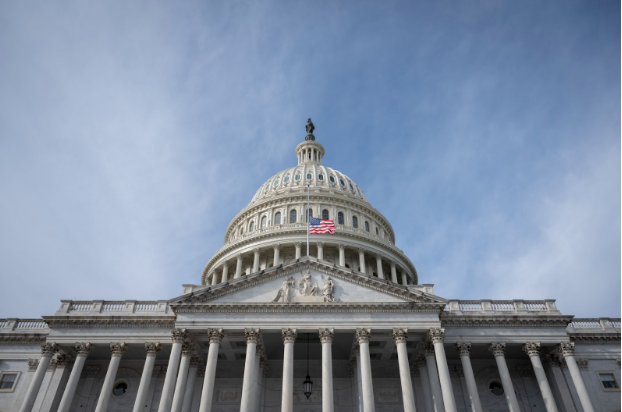An upward angle of the front of the United States Capitol during the day. (Benjamin Applebaum)