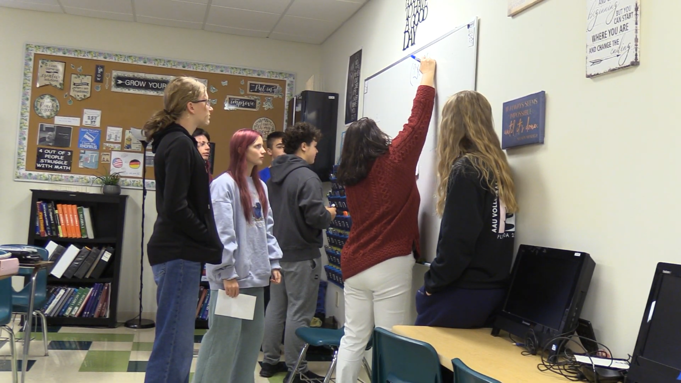 Ann Small, a Spectrum High School teacher of mathematics, gives group instructions to a conglomerate of her students.