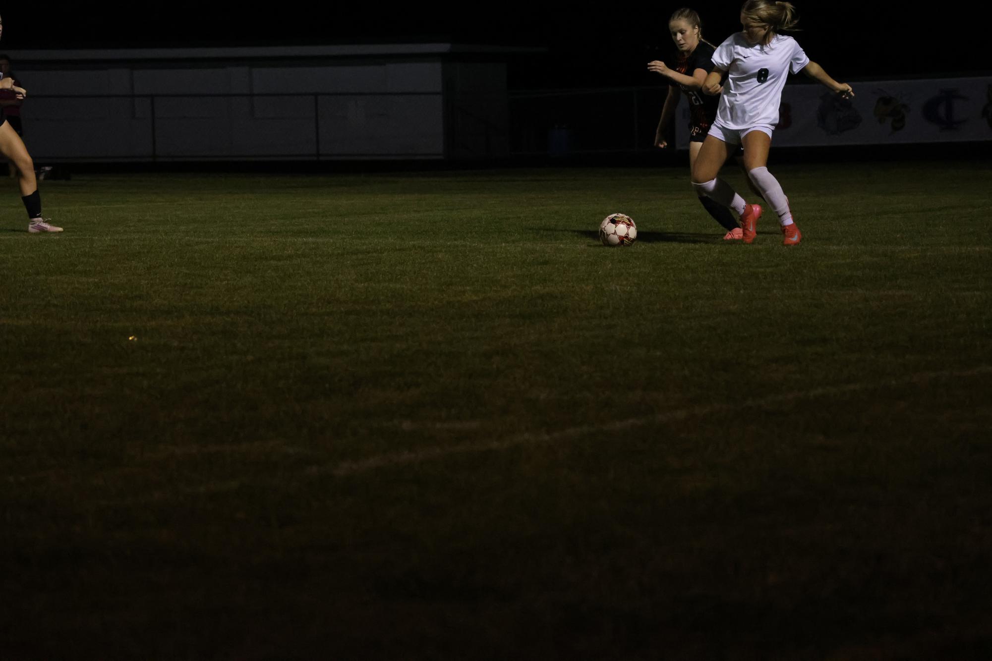 Girls varsity soccer player, Lily Beck, fights for the ball. Photo by Elaina Palmer.