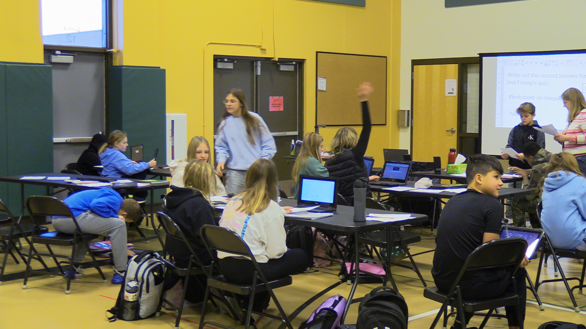 Sixth graders attending their math class in the elementary gymnasium