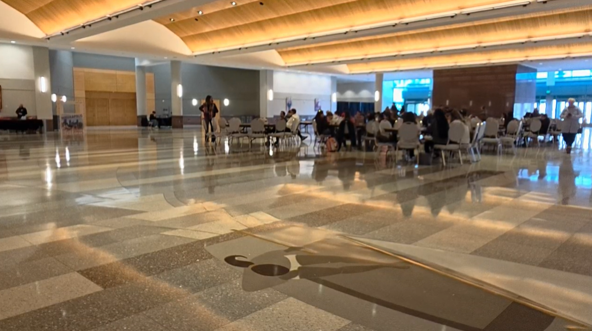 Students hanging out at tables with each other in the Minneapolis Convention Center